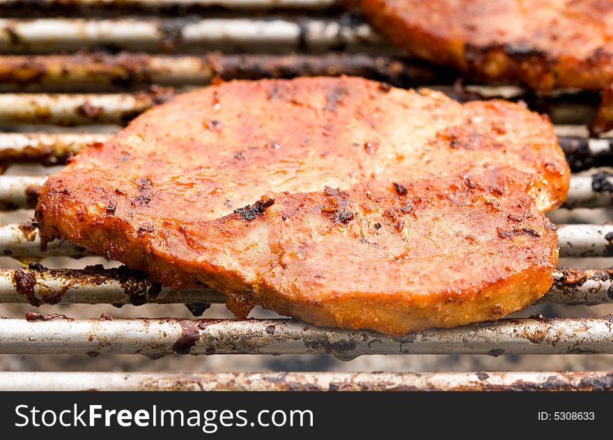 Barbecued steak on the grill. Barbecued steak on the grill.