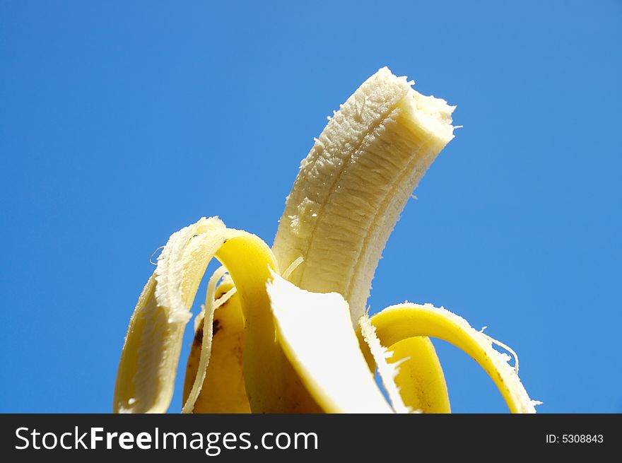 Detail of ripe fresh banana fruit against blue background