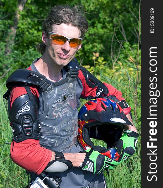 Portrait of downhill rider holding the helmet. Portrait of downhill rider holding the helmet