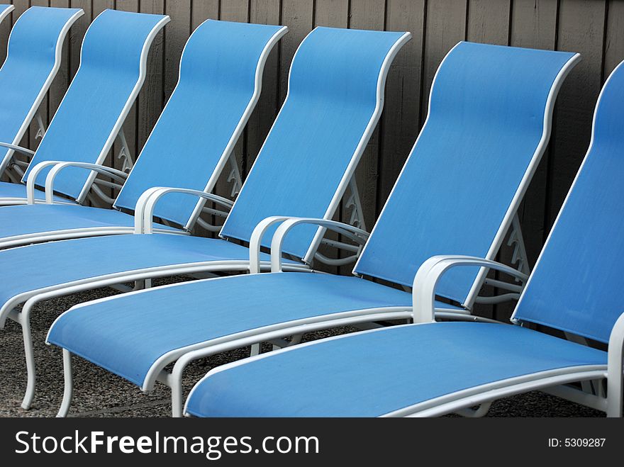 Row of new pool chaise lounges. Row of new pool chaise lounges.