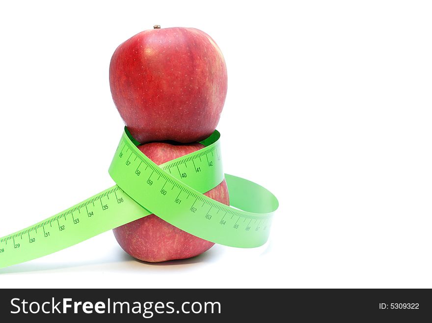Close-up of a red apples with a measuring tape around it. Close-up of a red apples with a measuring tape around it.