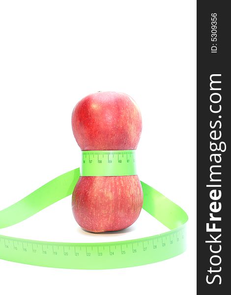 Close-up of a red apples with a measuring tape around it. Close-up of a red apples with a measuring tape around it.