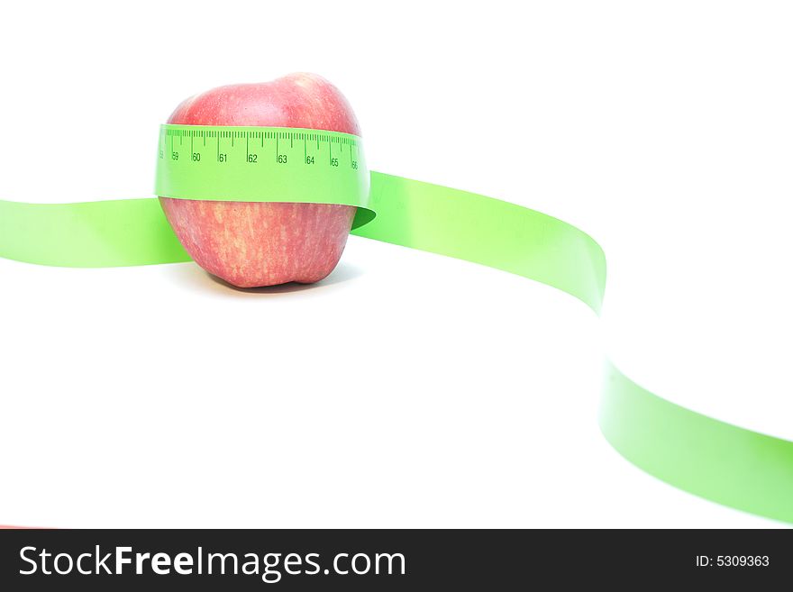 Close-up of a red apple with a measuring tape around it. Close-up of a red apple with a measuring tape around it.