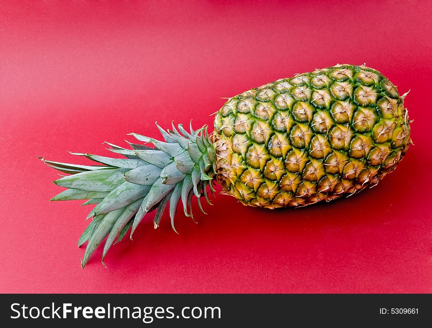 Pineapple on red.close up.