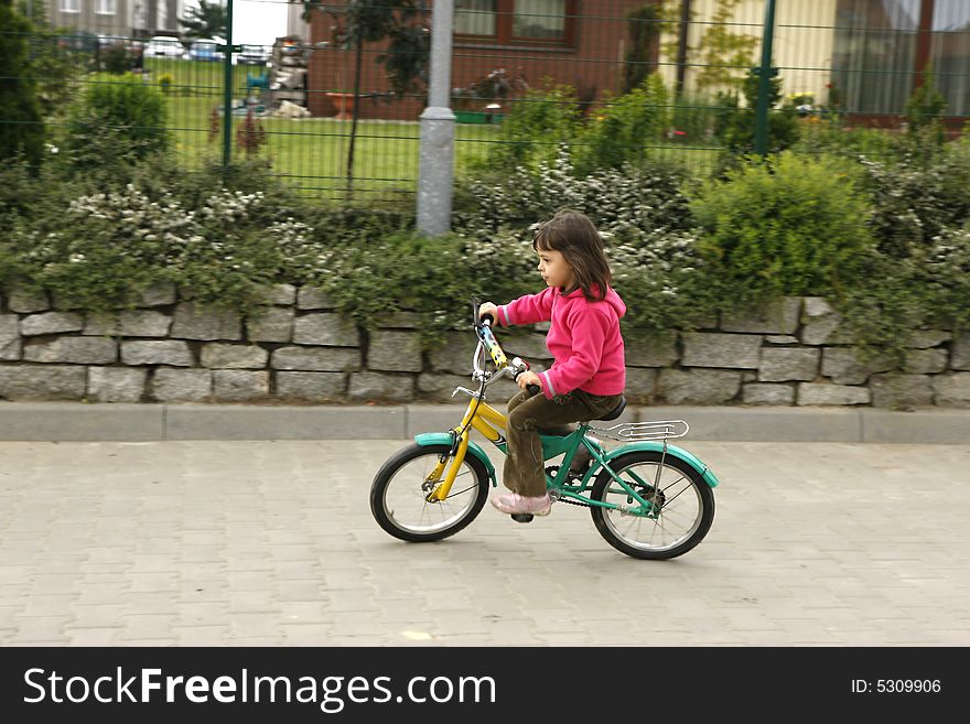 Little girl riding his bike