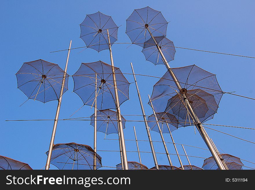 View on umbrellas against a blue sky