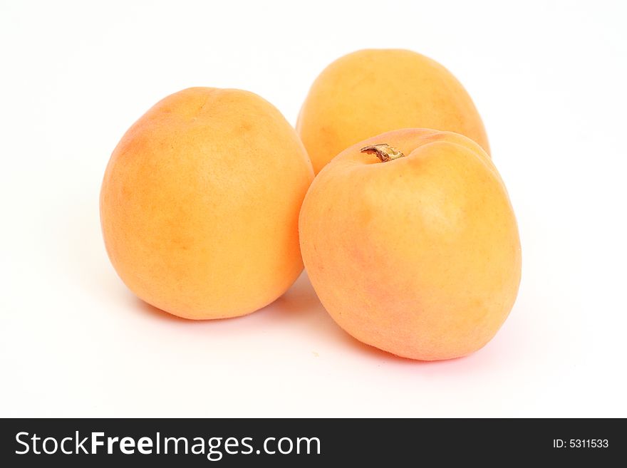 Three sweet apricots on white background