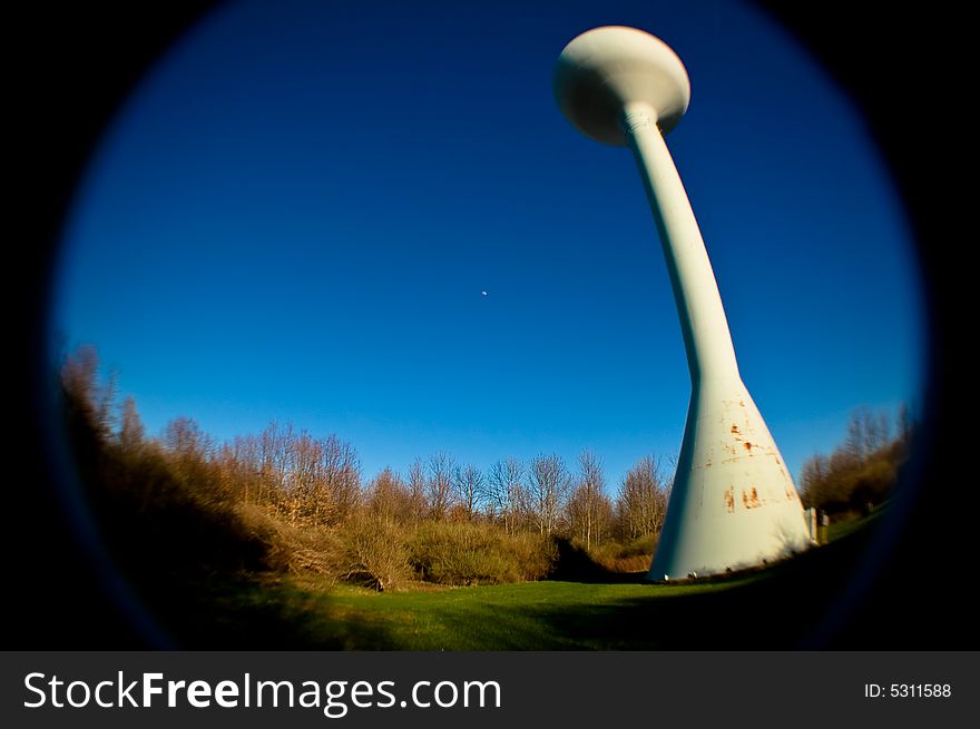 Water tower shot with fisheye lens, blue sky and field. Water tower shot with fisheye lens, blue sky and field.