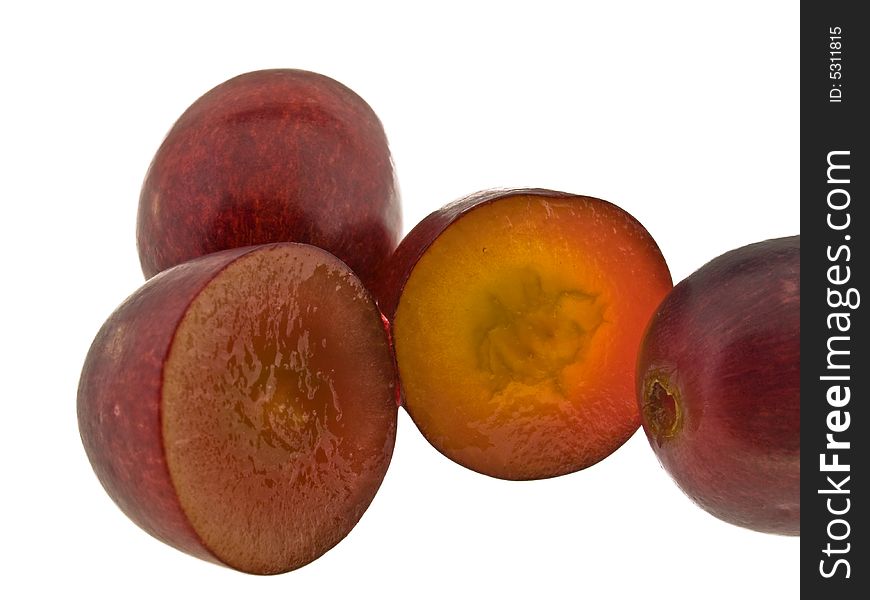 Red grapes macro with sliced grape isolated against white background. Red grapes macro with sliced grape isolated against white background