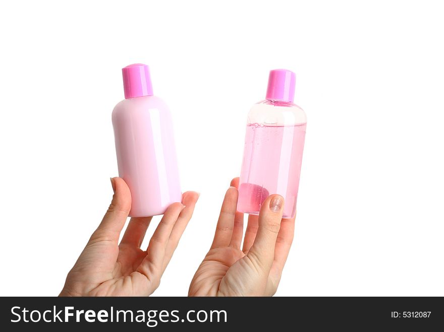 Female hands holding two bottles of perfume without  label