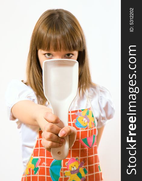 Young girl holding spoon on white