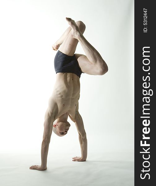 Professional fit male dancer in yoga position