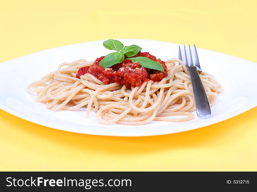 Spaghetti bolognese served on white plate