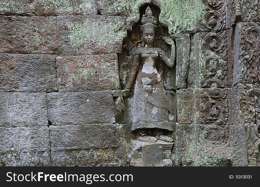 The Ta Prohm is an ancient Mahayana Buddhist monastery and university builted between the 12th and 13th centuries by the Khmer king Jayavarman VII. The walls are decorated with deep bas relief of female divinities, devatas or apsaras. The Ta Prohm is an ancient Mahayana Buddhist monastery and university builted between the 12th and 13th centuries by the Khmer king Jayavarman VII. The walls are decorated with deep bas relief of female divinities, devatas or apsaras.