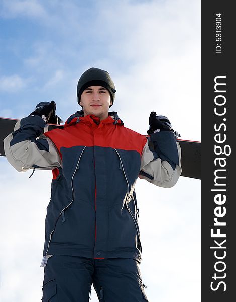 Young snowboarder on a background of the blue sky. Young snowboarder on a background of the blue sky