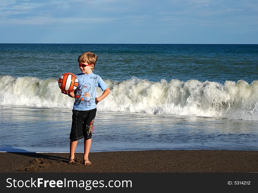 Joyful child play on coast of ocean. Joyful child play on coast of ocean