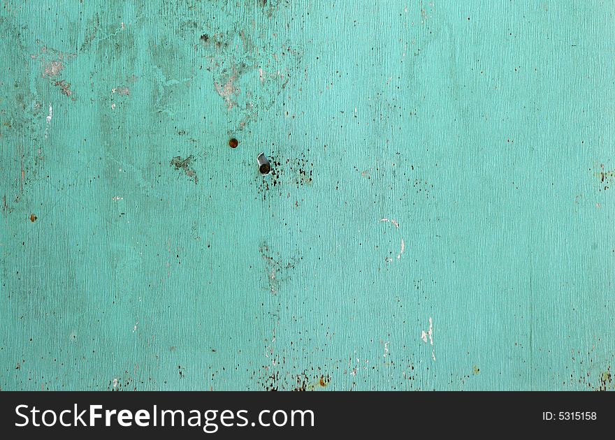 Blue wall texture with peeling paint