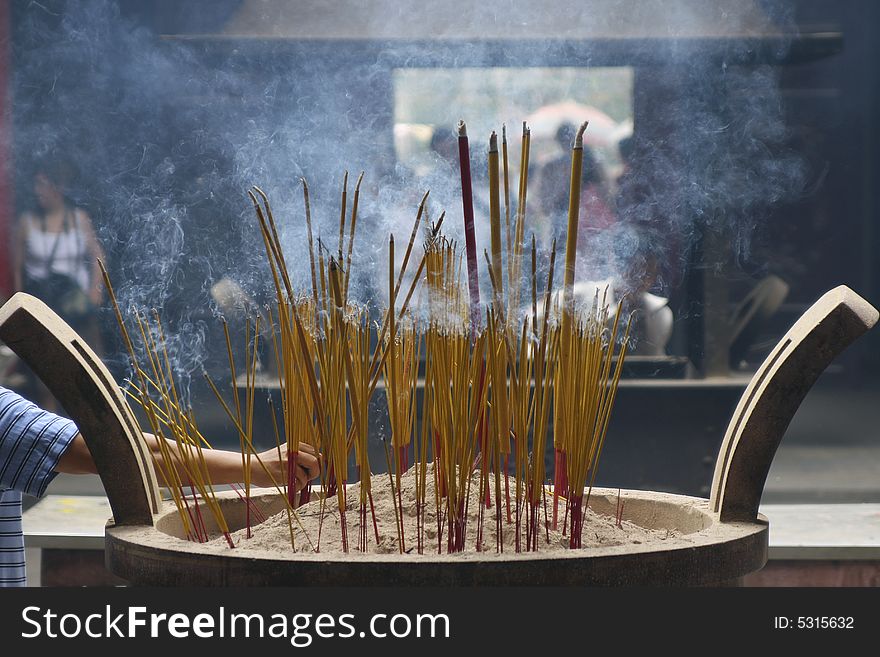 Burning incense stick in a pagoda