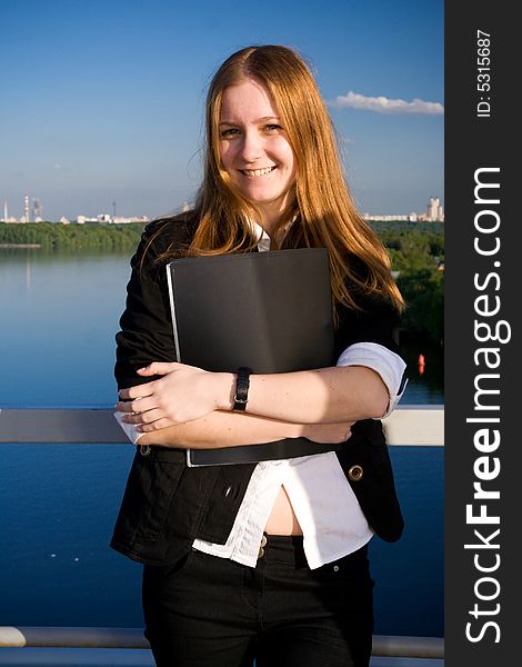 The Young Businesswoman With A Folder