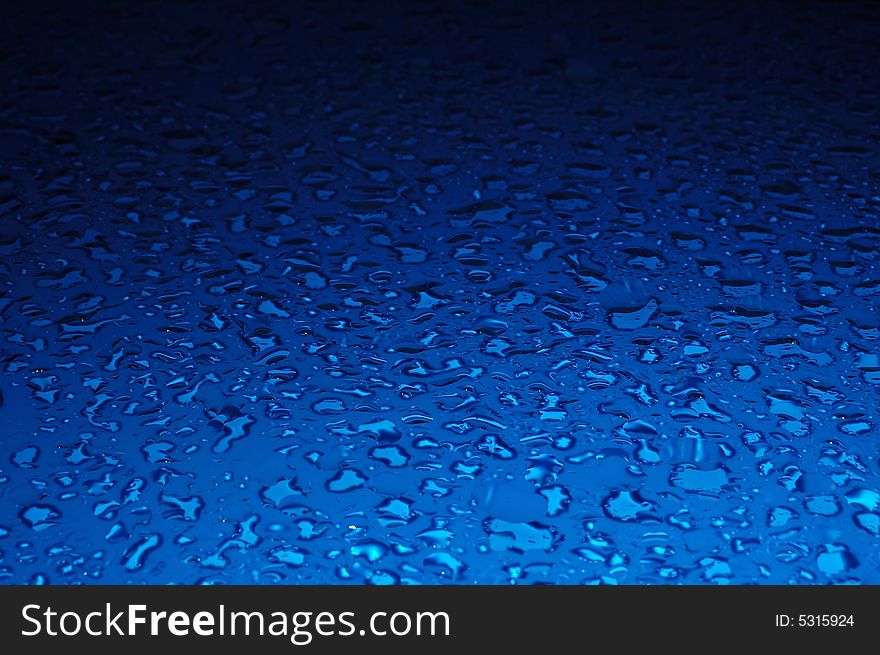 Water drops background texture in blue color