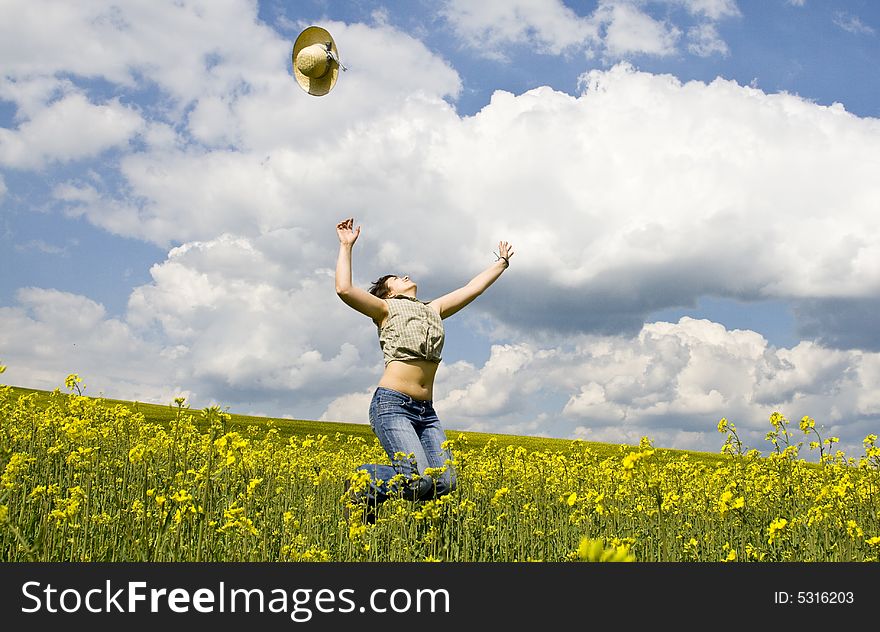 Girl having fun in summer rape field