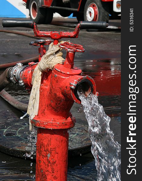 Red fire hydrant with flowing water
