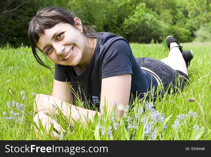 Young girl laying in grass