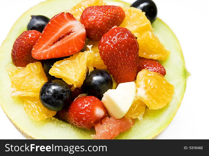 Fresh colorful fruits in a yellow melon. Fresh colorful fruits in a yellow melon