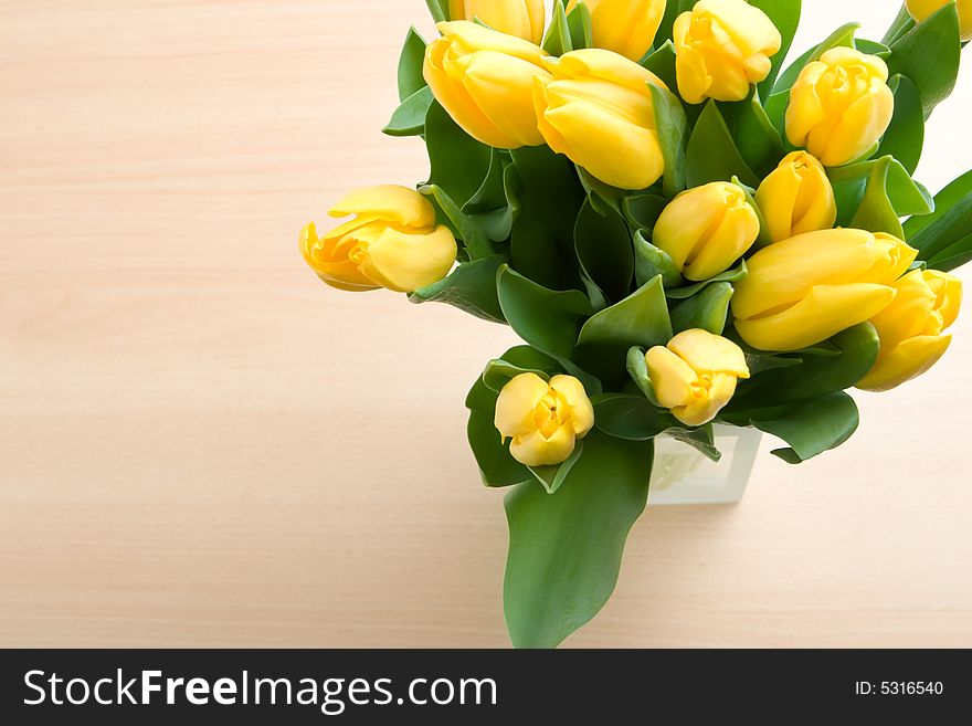 Bouquet of yellow tulips in vase close up