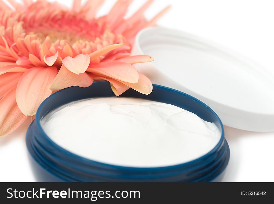 Moisturizing cream with orange gerbera close up