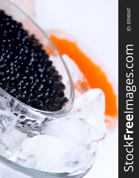 Black and red caviar in ice