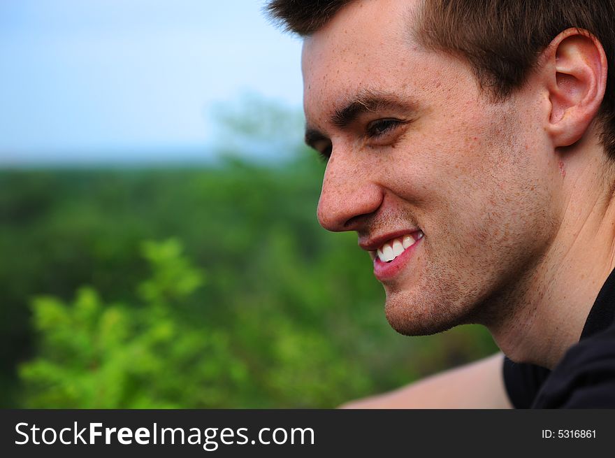 Close-up. The beautiful young smiling man of the outdoors. Close-up. The beautiful young smiling man of the outdoors