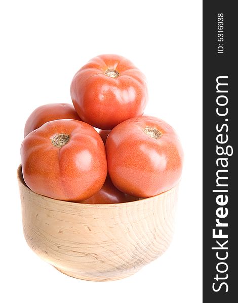 Fresh ripe red tomatoes in a wooden bowl on a white background. Fresh ripe red tomatoes in a wooden bowl on a white background