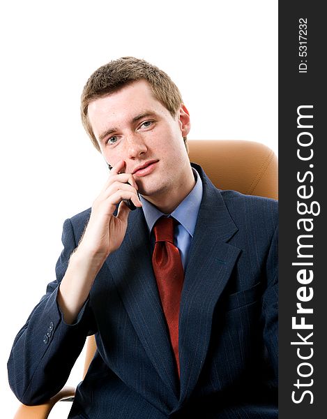 Businessman sitting on an armchair with cell phone. Isolated. Businessman sitting on an armchair with cell phone. Isolated