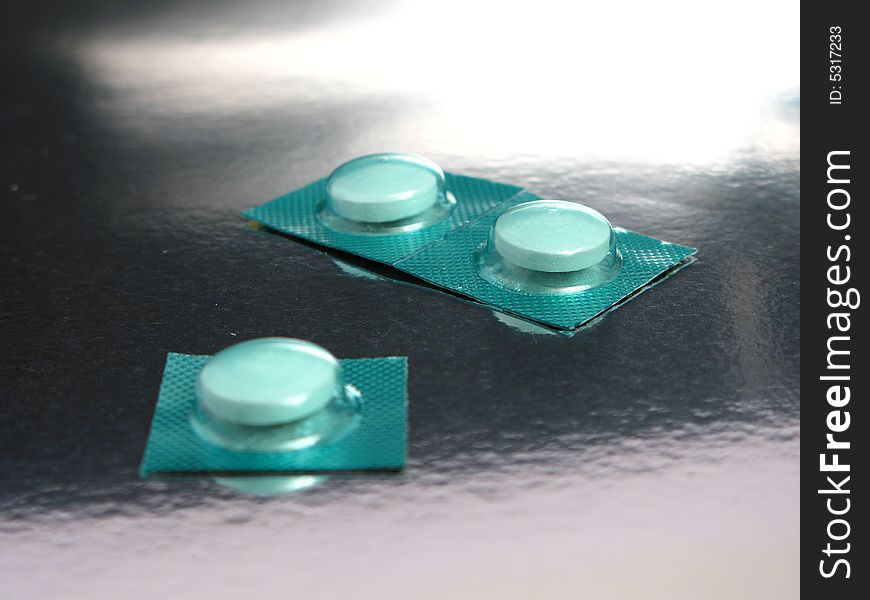 Packed medicines in a silver background