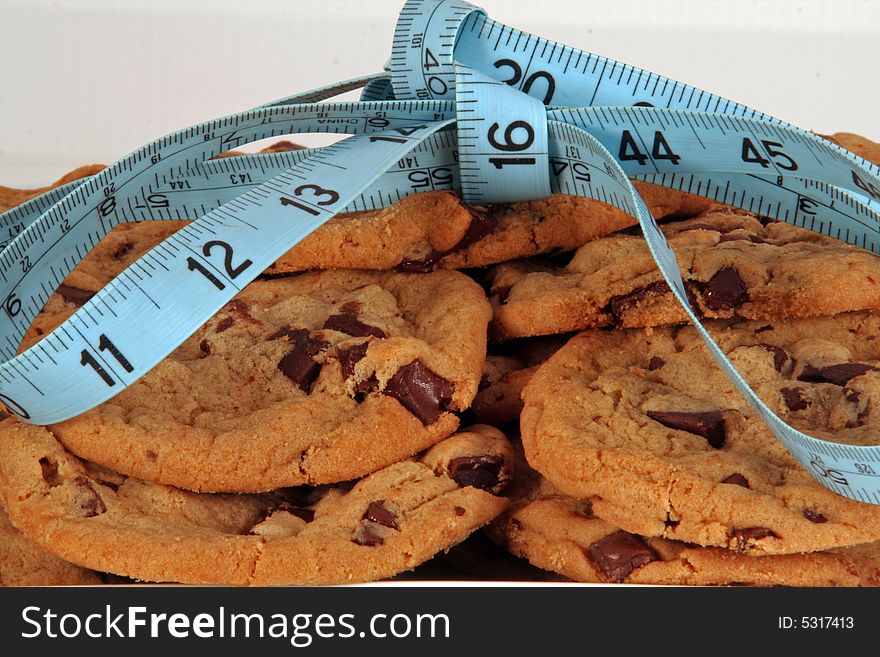 Chocolate chip cookies tied in a bow with a tape measure. Chocolate chip cookies tied in a bow with a tape measure