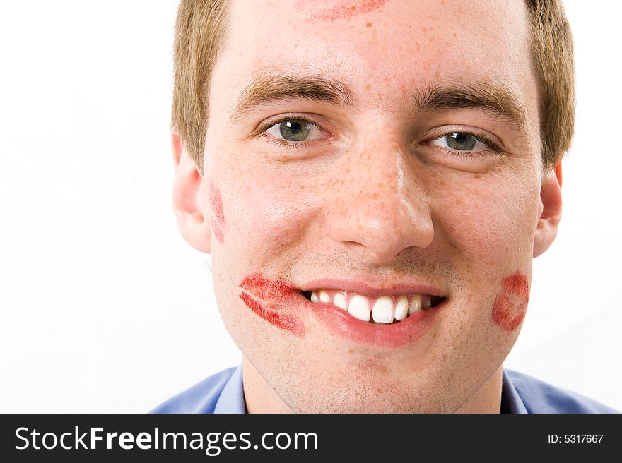 Close-up. The Happy young man smiling. Trace of a kiss on a cheek