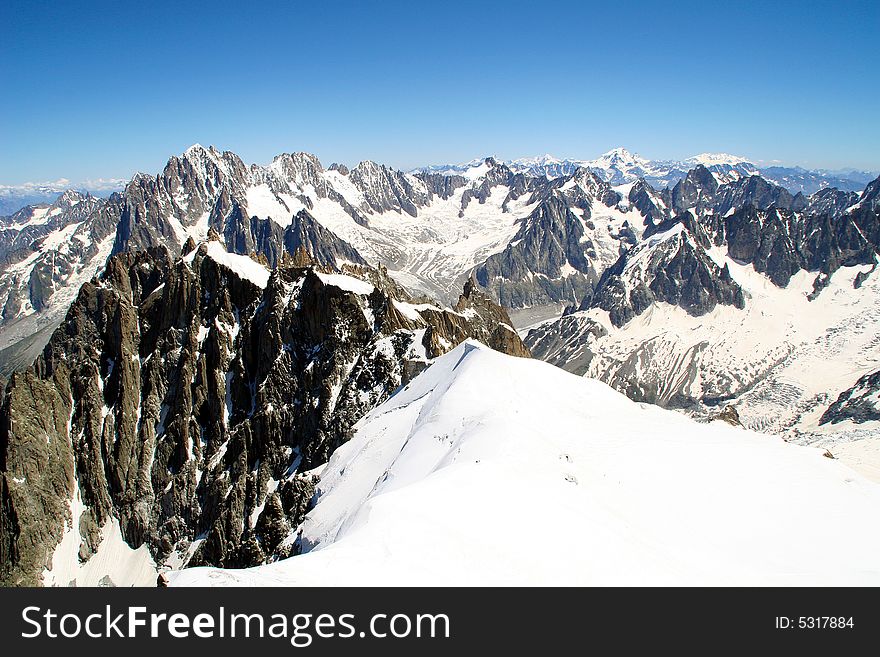 The snowy alps as seen from a high vantage point. The snowy alps as seen from a high vantage point