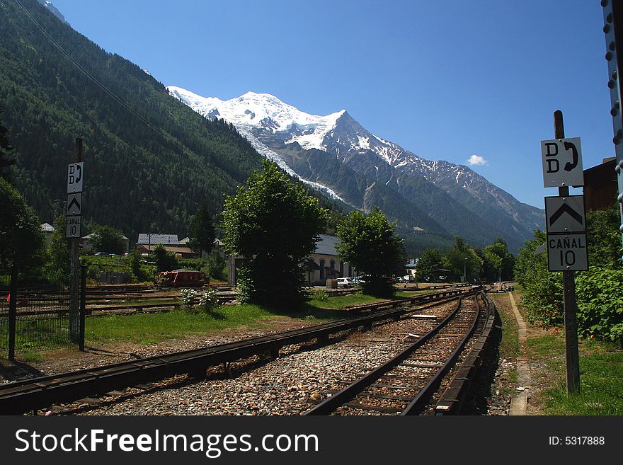 Train station in a valley in Europe at the base of the alps