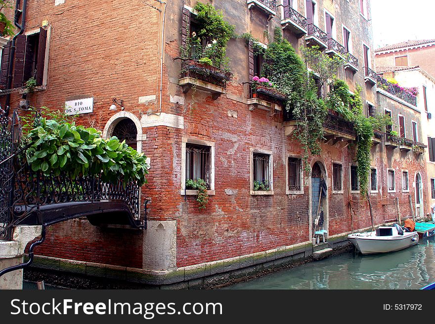 Venice Italy waterway with boats and red brick