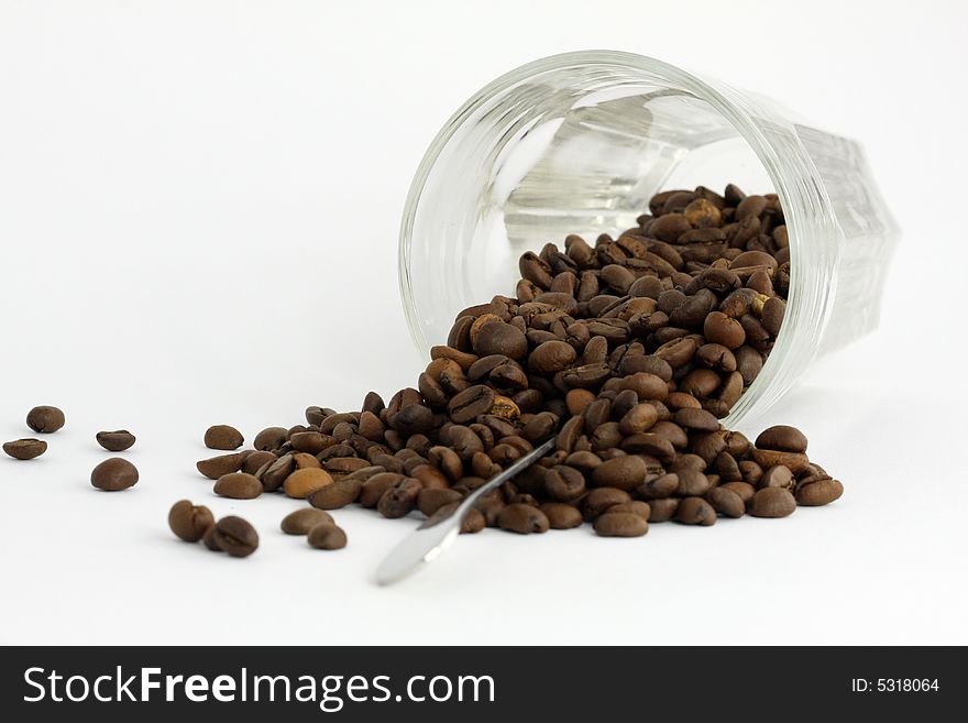 Coffee Grains And Upset Glass