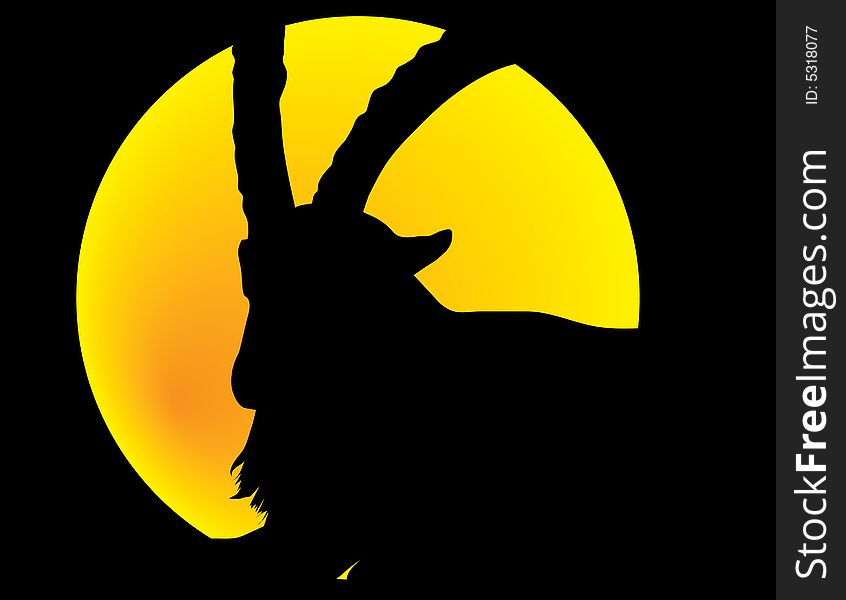 Silhouette of horned animal front of moon