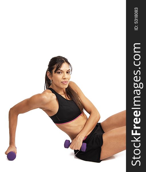 Beautiful brunette woman exercising with purple dumbbells