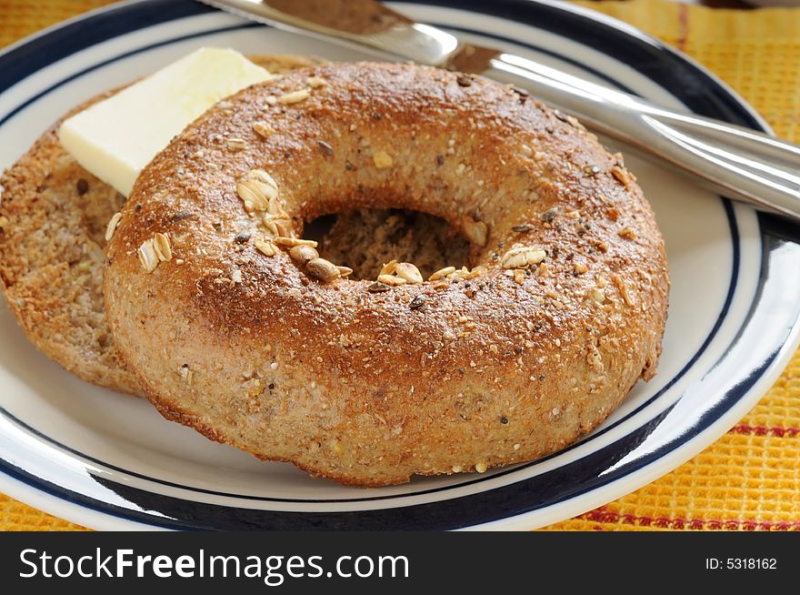 Toasted whole grain bagel with butter sliced.