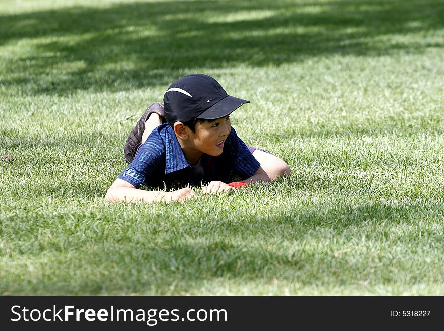 A lovely and naughty boy climbed on the meadow. A lovely and naughty boy climbed on the meadow.