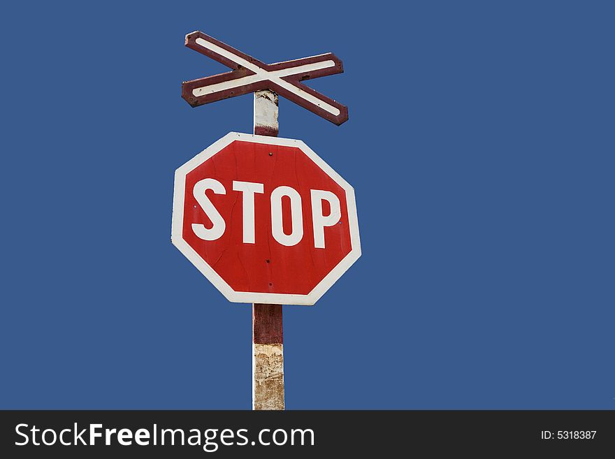 Stop Sign on railway on blue sky