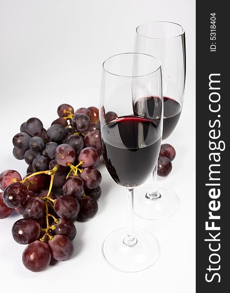 Glasses of red wine with grapes. Glasses of red wine with grapes