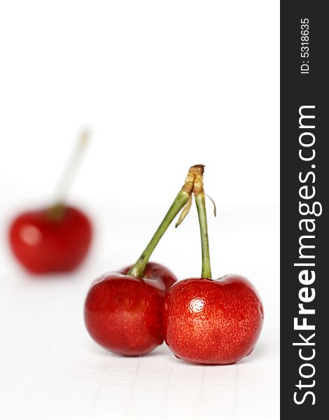 Red cherry in white background.