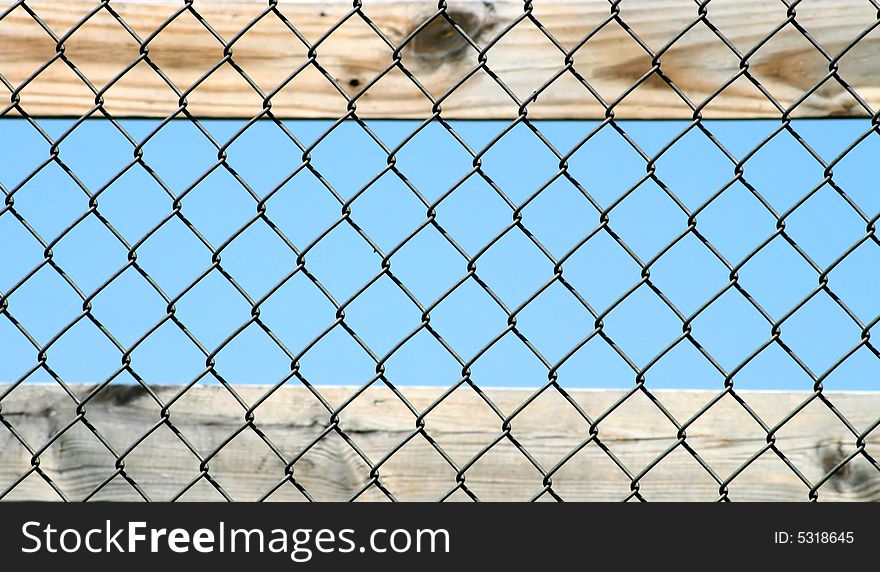 Pine board, top and bottom, with chain link fence overlay. Pine board, top and bottom, with chain link fence overlay