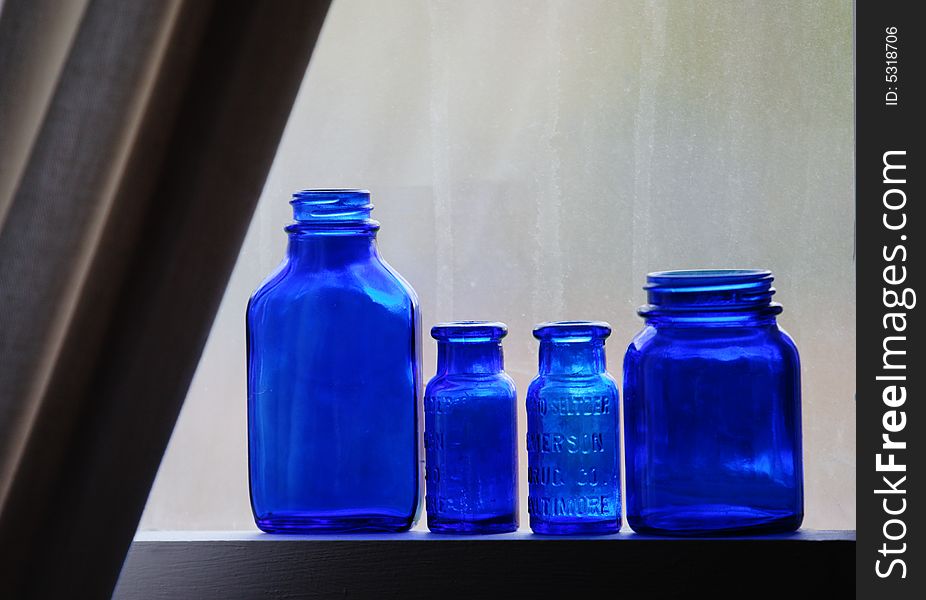 Blue bottles on window sill